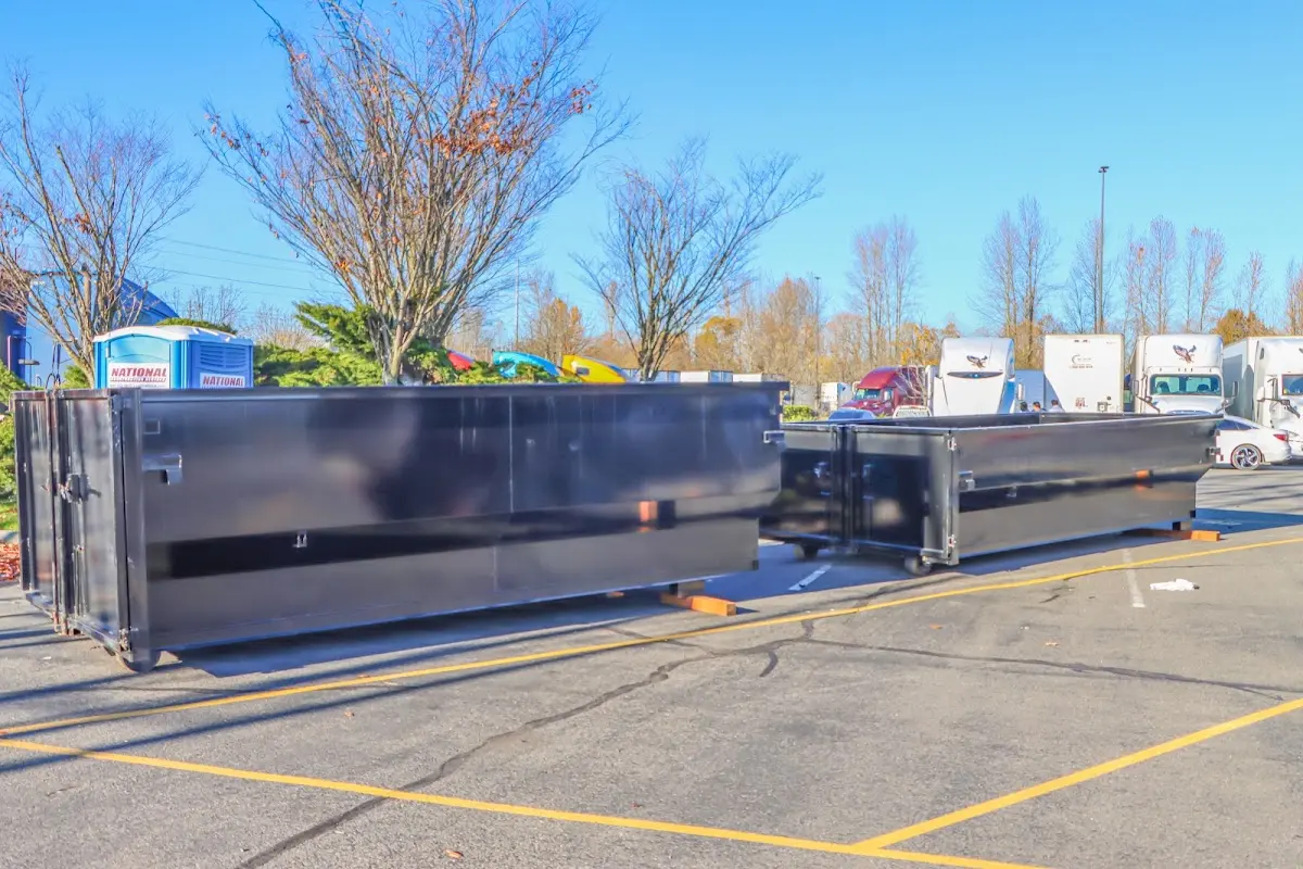 Professional dumpster rental service with roll-off container on residential driveway in El Cerrito